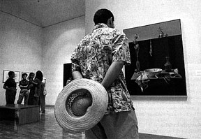 [Photo: visitor admires exhibition at Olin]