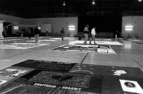 [Photo: panels of the AIDS quilt in the Cage]